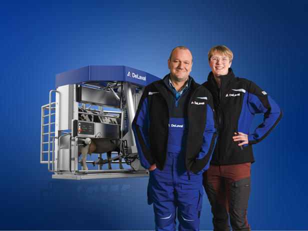 DeLaval staff with a DeLaval milking system